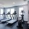 A row of treadmills and elliptical machines overlooking the ocean.