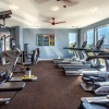 Large well lit fitness center with large windows 