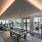 Large well lit game room with bar seating and two billiard tables 