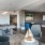 Spacious and well lit game room with billiard tables and plenty of seating.