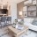 Spacious and well lit living room with wood floors and an open floor plan with access to the kitchen.